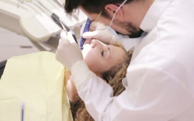 Male Dentist Working on Woman's Teeth